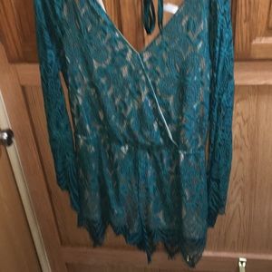 This is a greenish and nude lace Romper. brand new